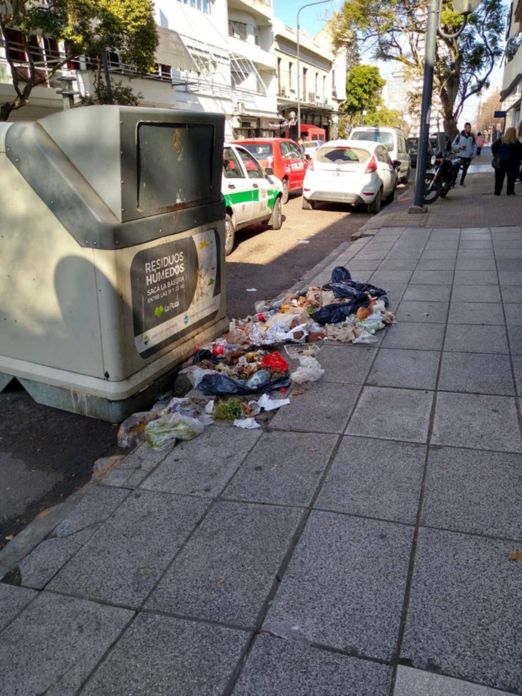 Basura alrededor de un contenedor céntrico